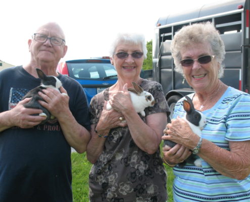 Seniors Holding Bunnies
